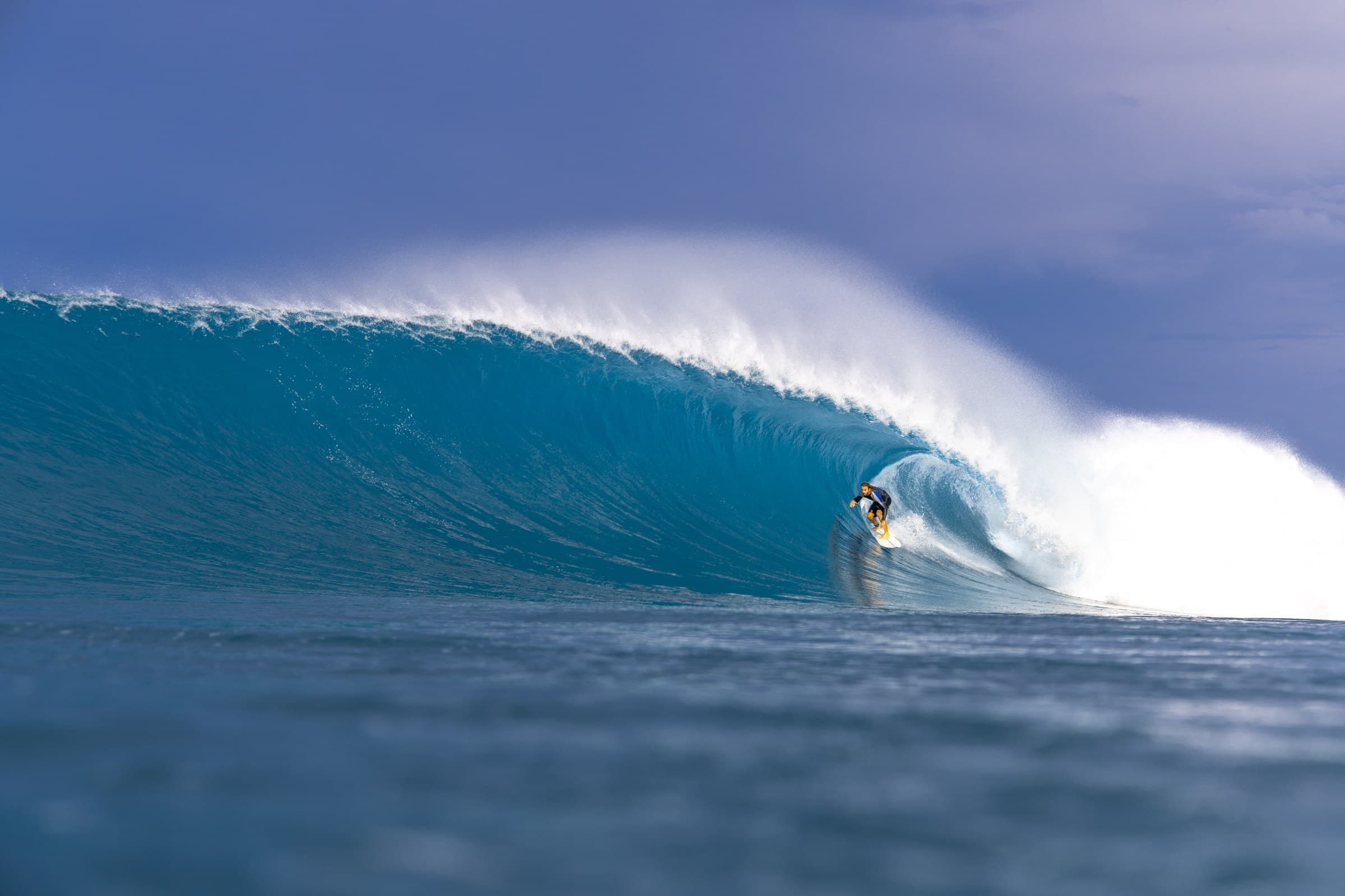 A surfer under the lip on a clean wall at Lance’s Right